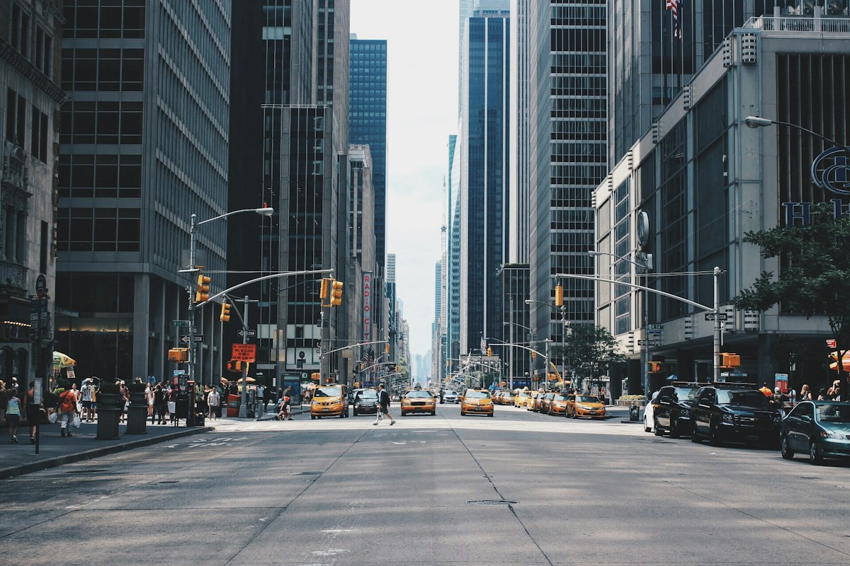 Street-level view of a busy city, beyond the browser